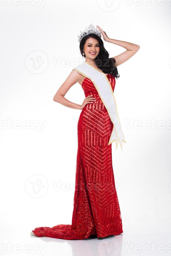 Full Length of Miss Pageant Contest in Asian Red Sequin Evening Ball Gown dress with Silver Diamond Crown Sash, fashion make up face hair style, studio lighting white background isolated copy space photo