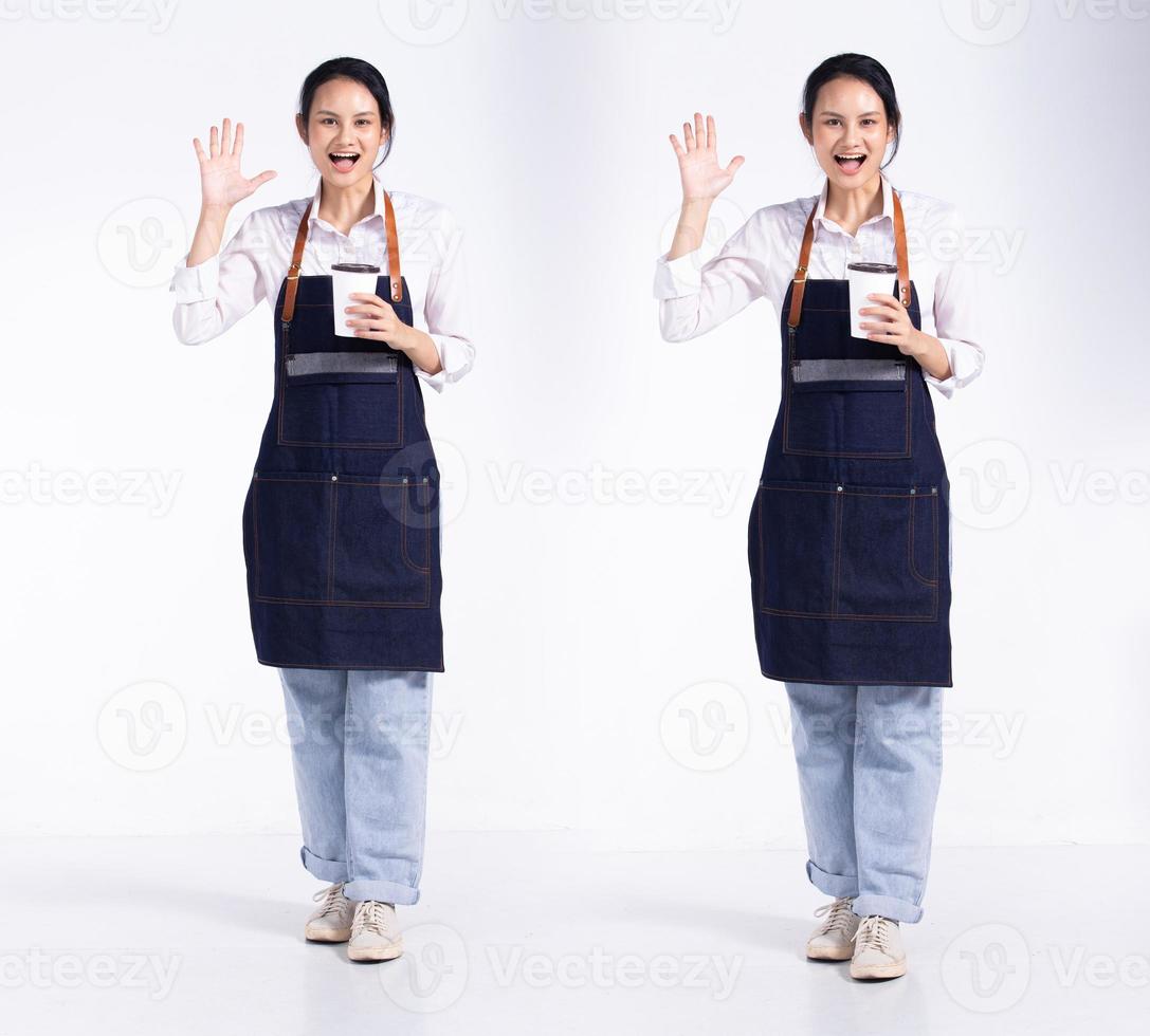 Full length 20s young Mix Race Barista shop restaurant Woman, wow surprise sign hand, wear apron coffee cup. Office female stands feels smile happy over white background isolated photo