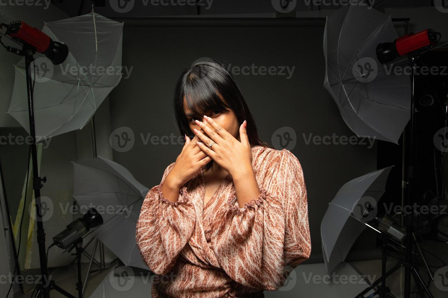 mujer india asiática muestra una hermosa sonrisa labios felices, poses de moda en un estudio fotográfico con equipo foto