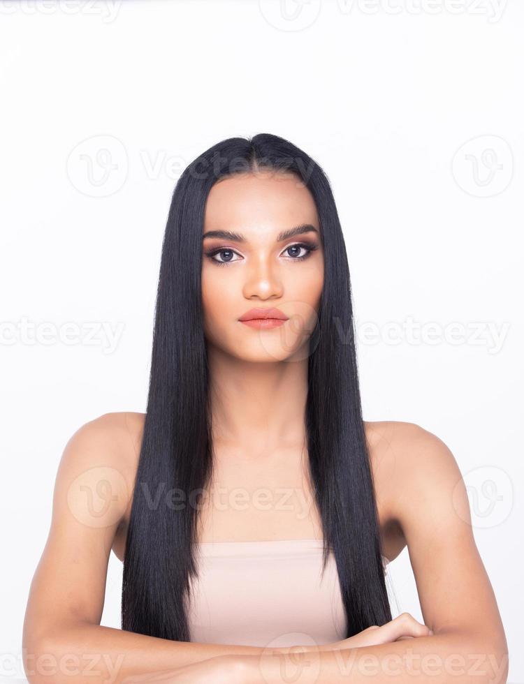 Beautiful fresh skin woman open shoulder with clean look make up and long black hair. Portrait young girl in attractive natural fashion face express feel smile, show eye lip, isolated white background photo