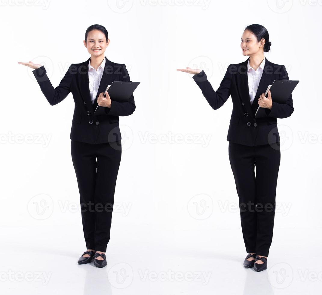 Full length 20s young Mix Race Woman teacher student lawyer, showing empty palm hand, wear black formal blazer and shoes. Office female stands feels happy smile over white background isolated photo