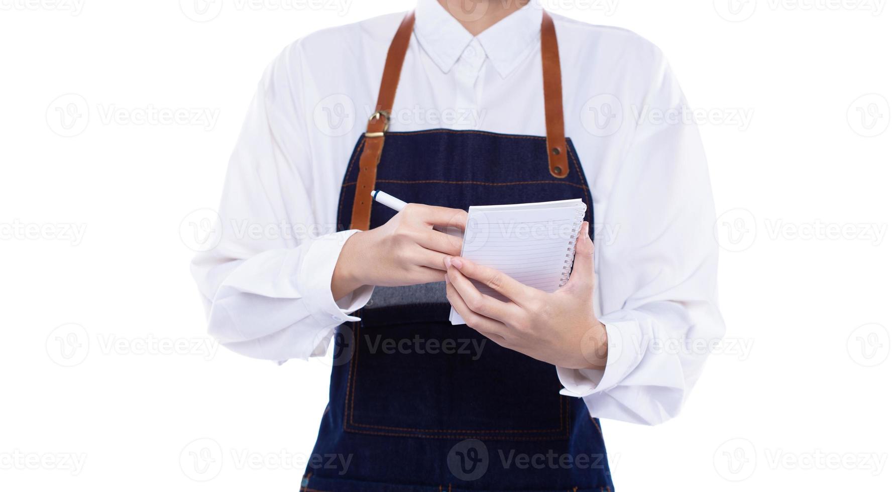 Waitress hold menu note order to service customer client in shop restaurant with smile. Employee staff wear apron to serve as entrepreneur owner for small business, copy space white background photo