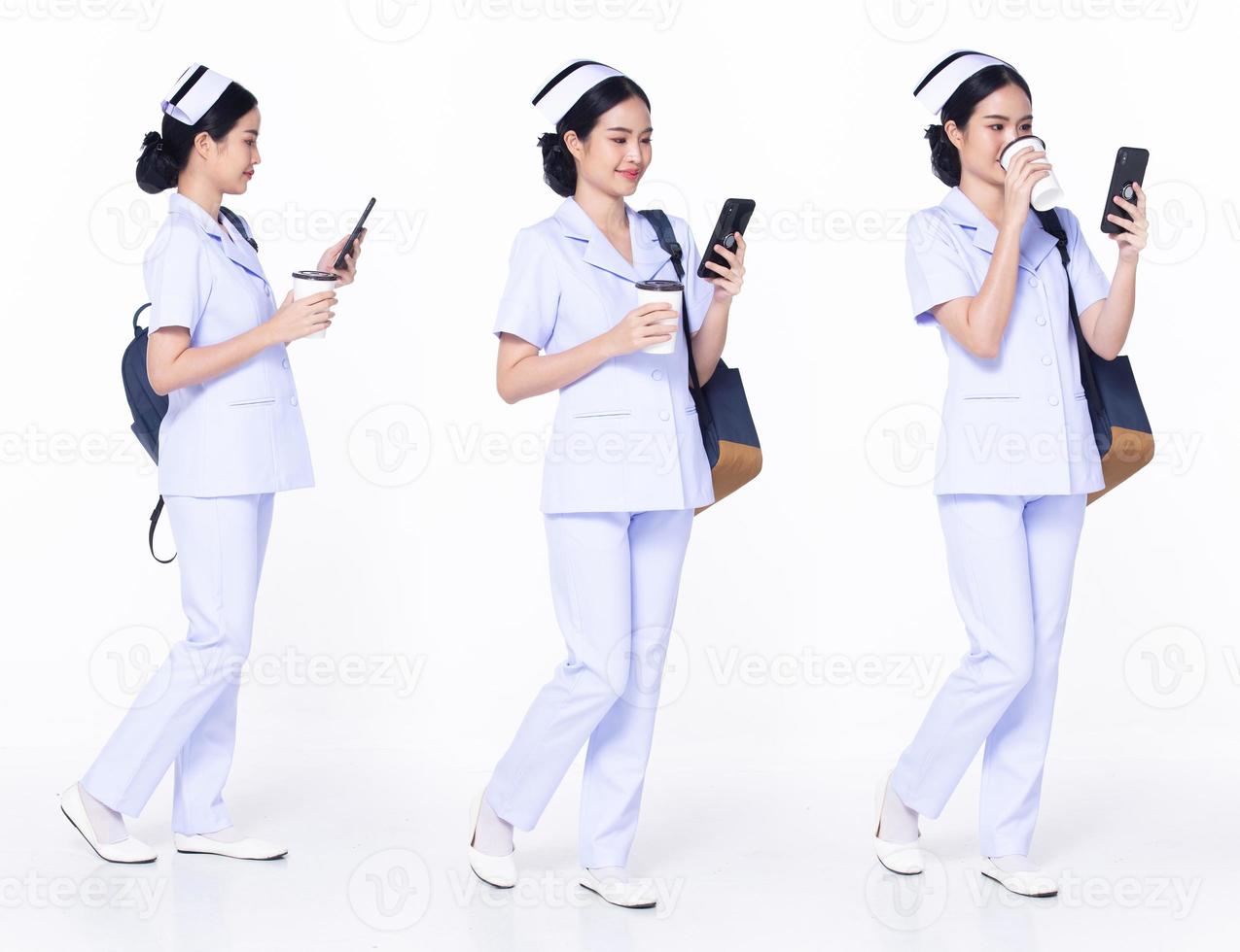 Full length 30s 20s Asian Woman Nurse hospital, walking forward left right, wear formal uniform pant shoe. Smile Hospital female carry backpack coffee cup internet phone over white background isolated photo