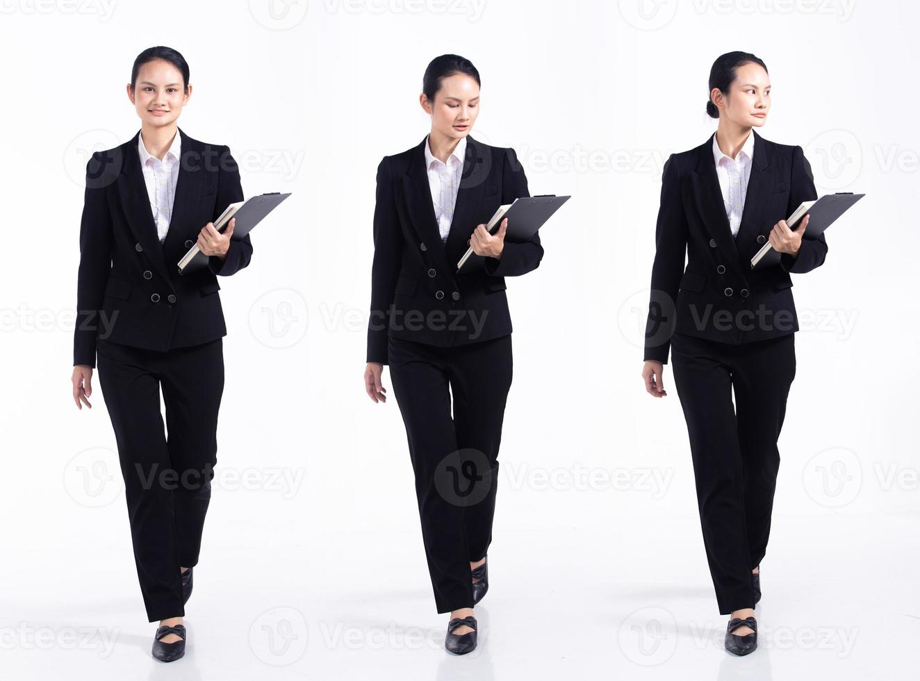 Full length 20s young Mix Race Woman teacher student lawyer, walking forward left right, wear black formal blazer and shoes. Office female feel happy smile over white background isolated photo