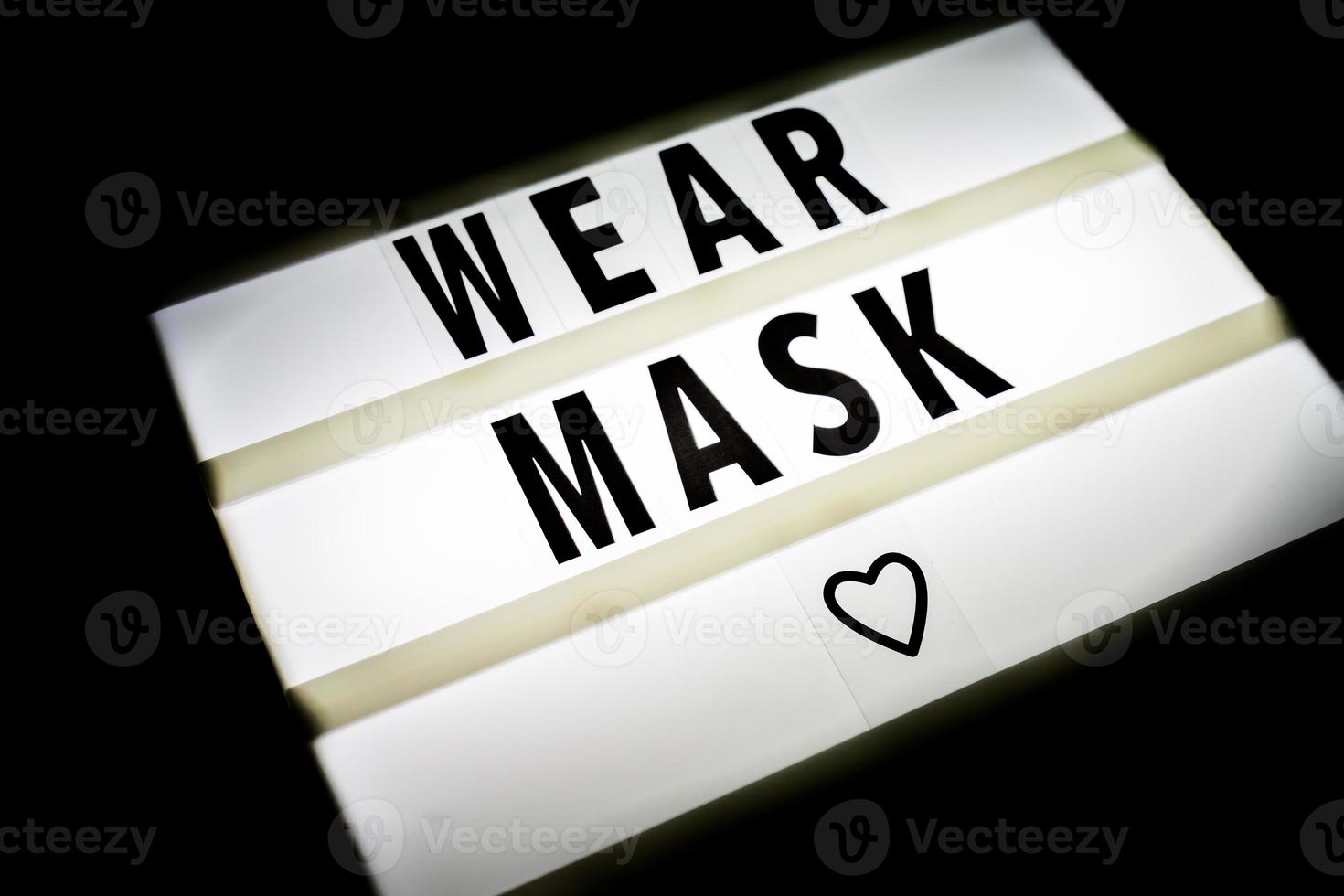 Light box sign with quote Wear mask on black background. protective measures against Coronavirus. photo