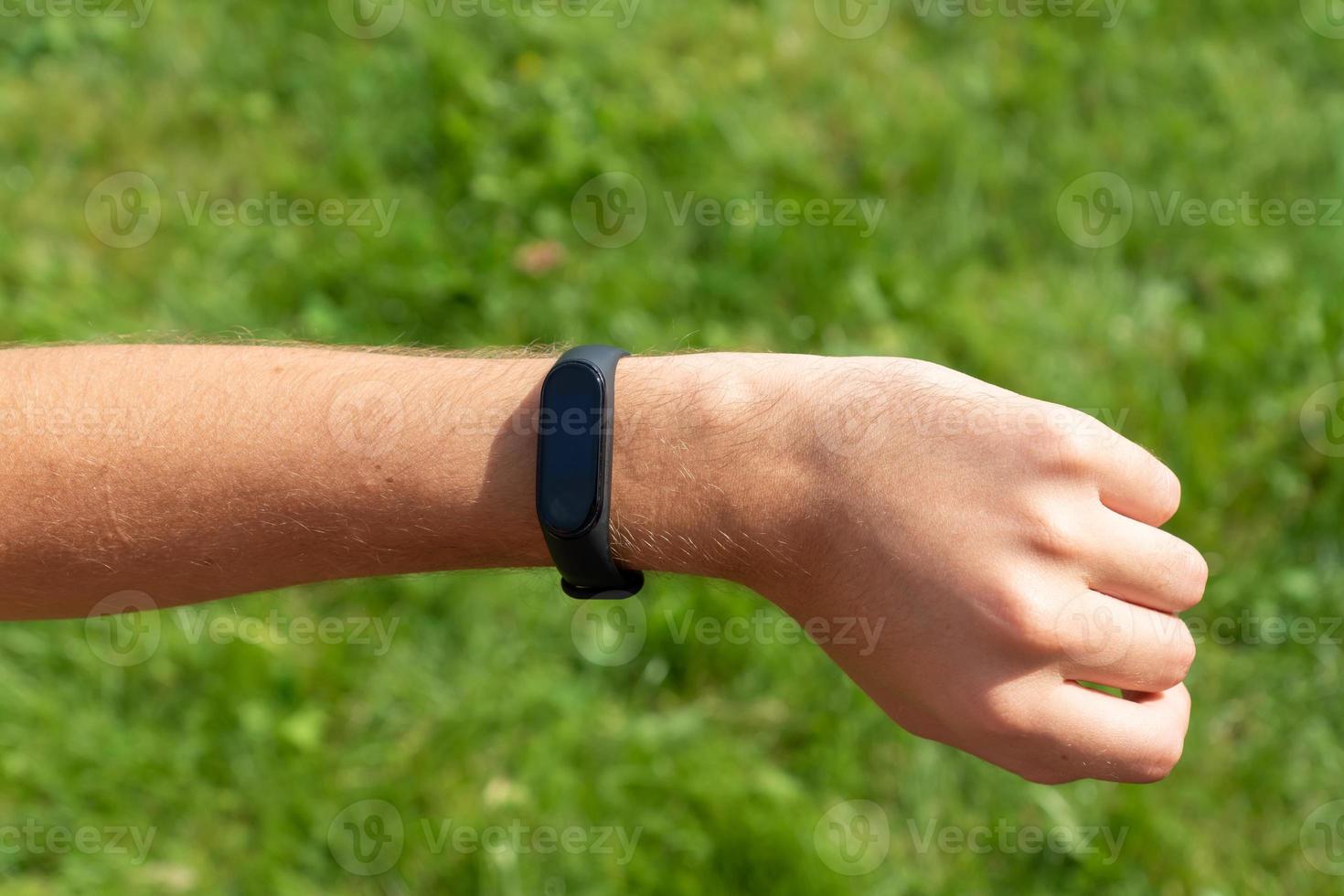 Close-up Of A Person Hand Wearing Smart Watch. fitness man using smart watch. photo