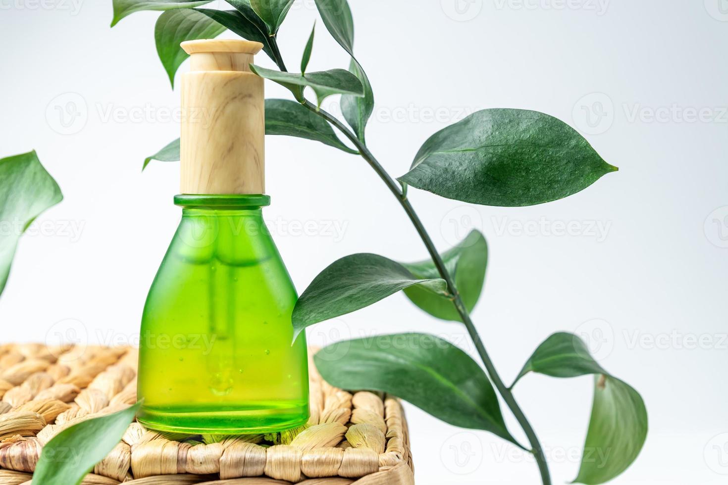 Dropper of essential oil, aromatherapy essence, beuty serum or medicinal liquid on natural background. Unbranded bottles for your design. photo