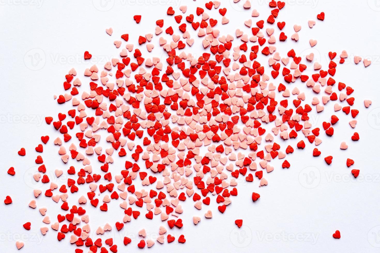 sprinkles background, sugar sprinkle red hearts, decoration for cake and bakery. Top view, flat lay. Valentines holiday photo