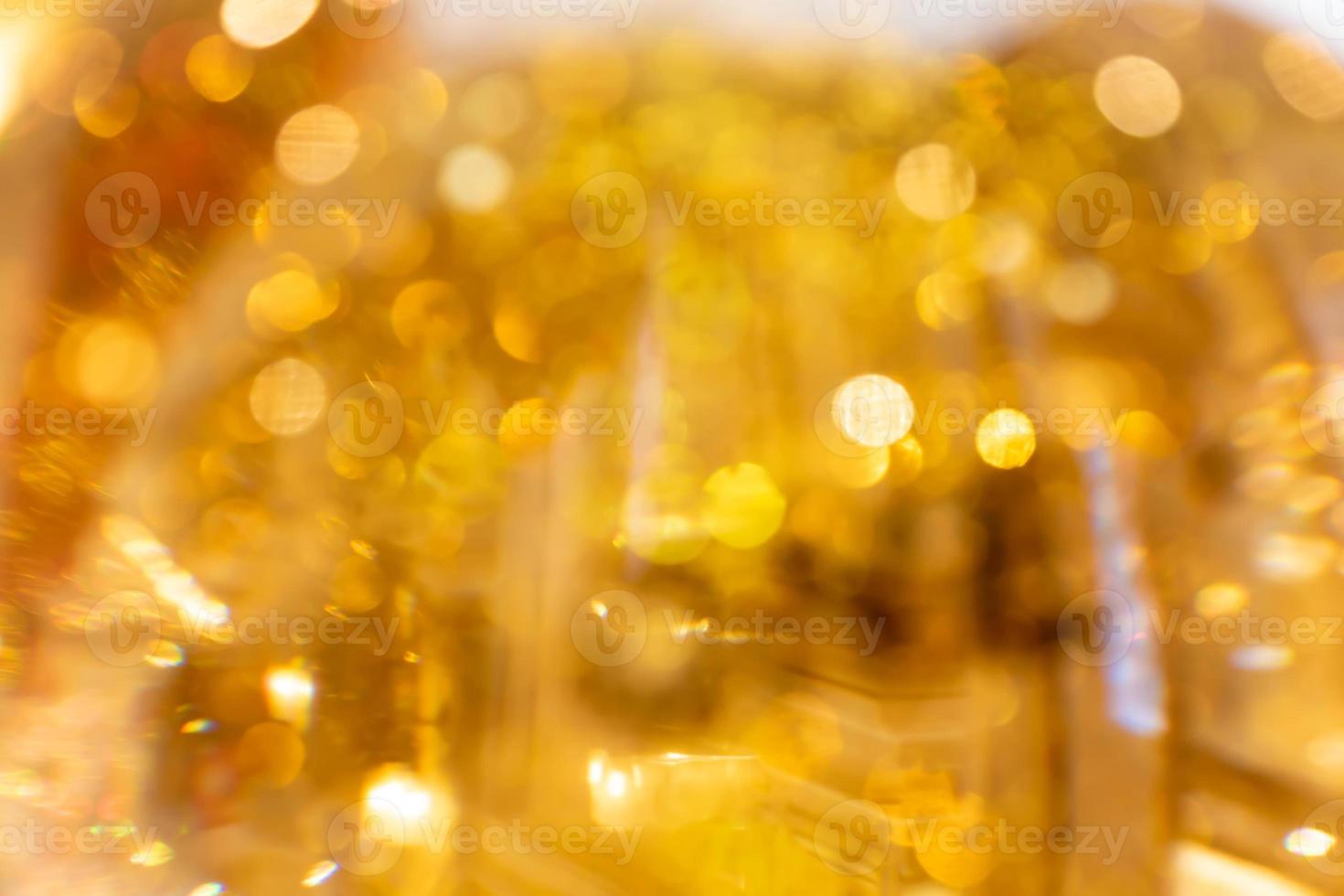 Golden glowing bokeh background. Abstract bright glittering backgdrop. Defocused image photo