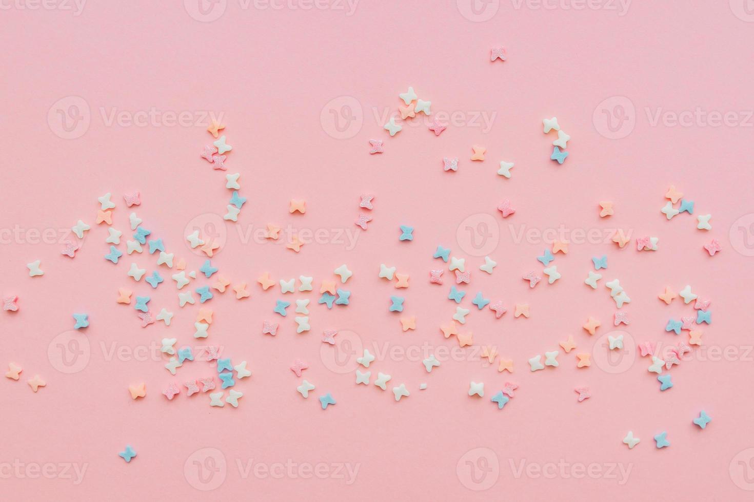 sprinkles background, sugar sprinkle butterflies, decoration for cake and bakery. Top view, flat lay. pastel colors. photo