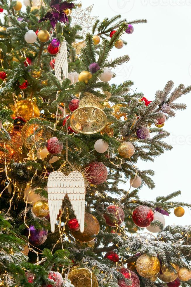 close up of christmas tree decoration with baubles and snow icing. Festive greeting card for winter holidays in golden colors. photo