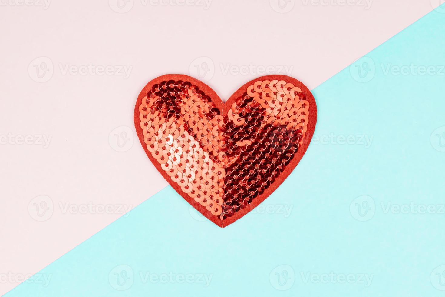 Red sequins heart on blue and pink background. Creative minimal layout with copy space for St Valentine Day. photo