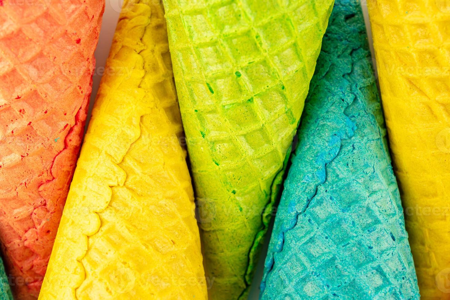 Set of various bright multicolored ice-cream waffle cones on white background . photo