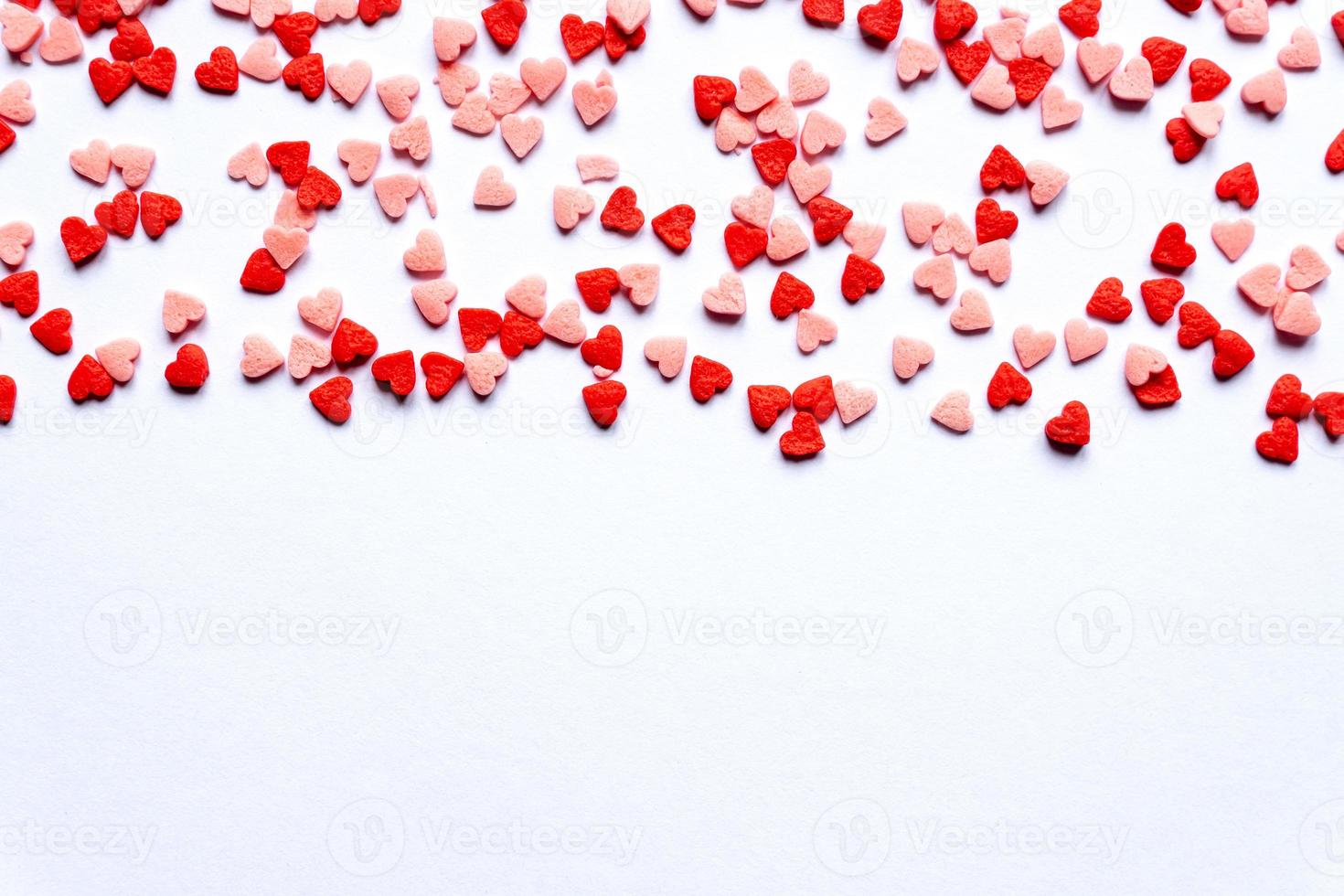sprinkles background, sugar sprinkle red hearts, decoration for cake and bakery. Top view, flat lay. Valentines holiday photo