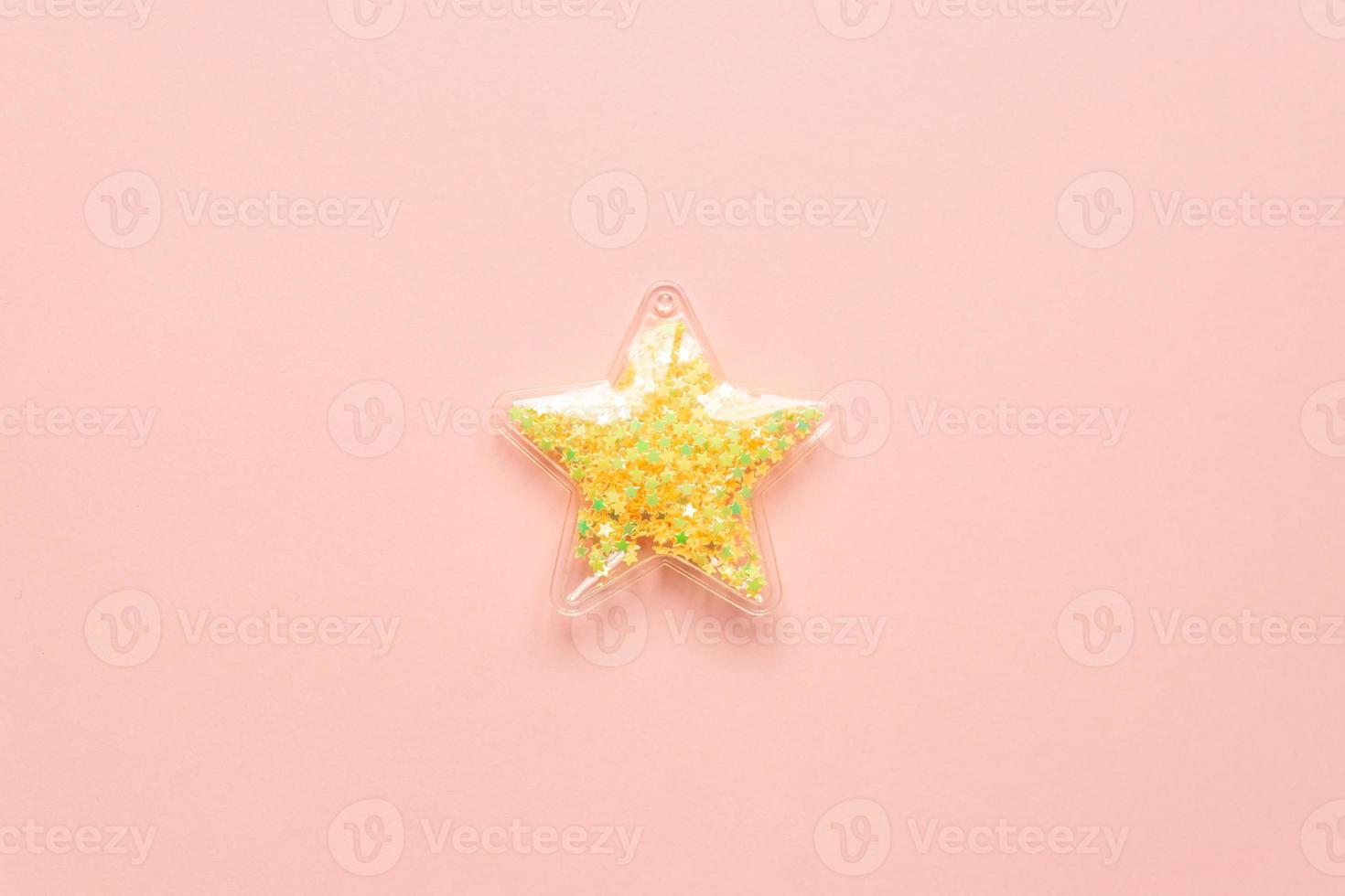 Minimalism concept with yellow star on pink background, top view, copy space. photo