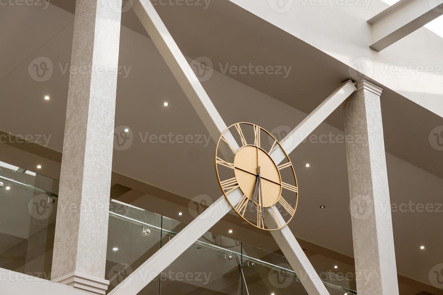 Modern clock on the second floor on the wall photo