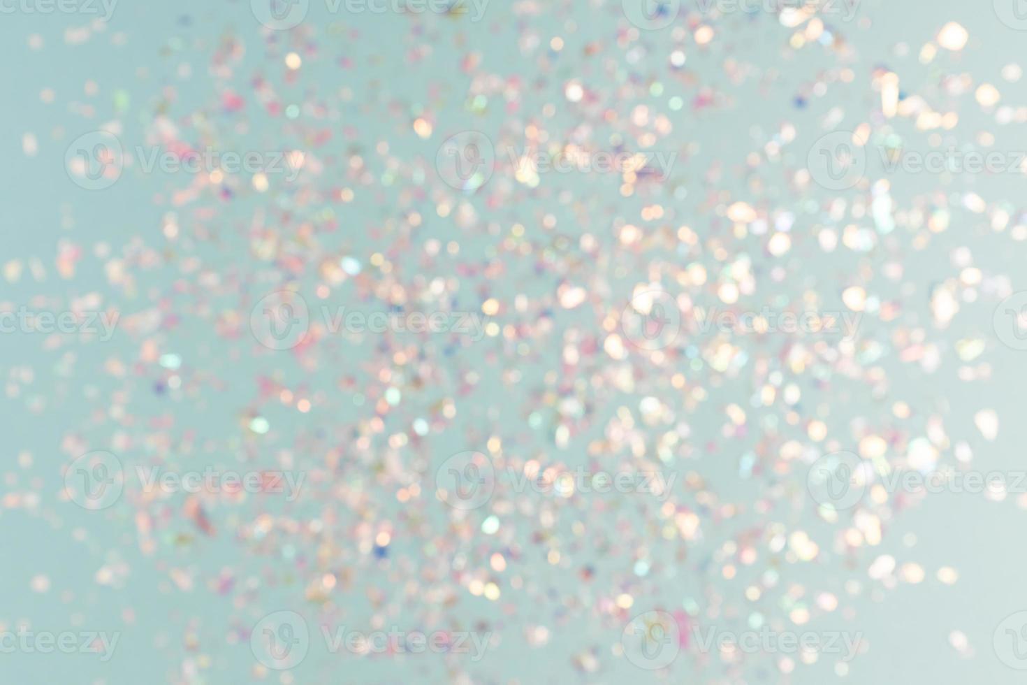 pearl confetti sparkles on blue holiday background. Festive backdrop or greeting card for designers. photo