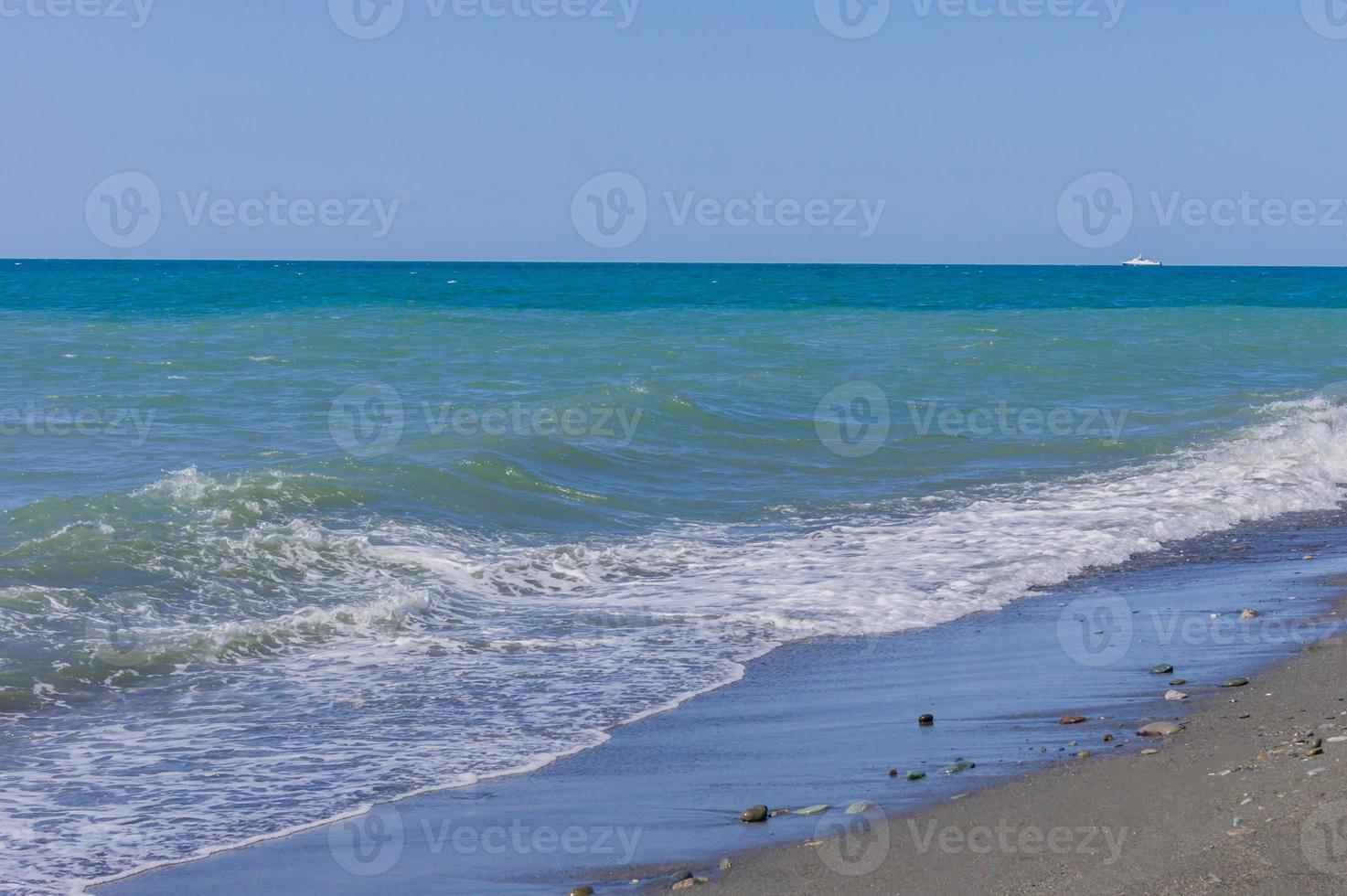 sea vawes run to she pebble shore. Plack Sea coast line photo