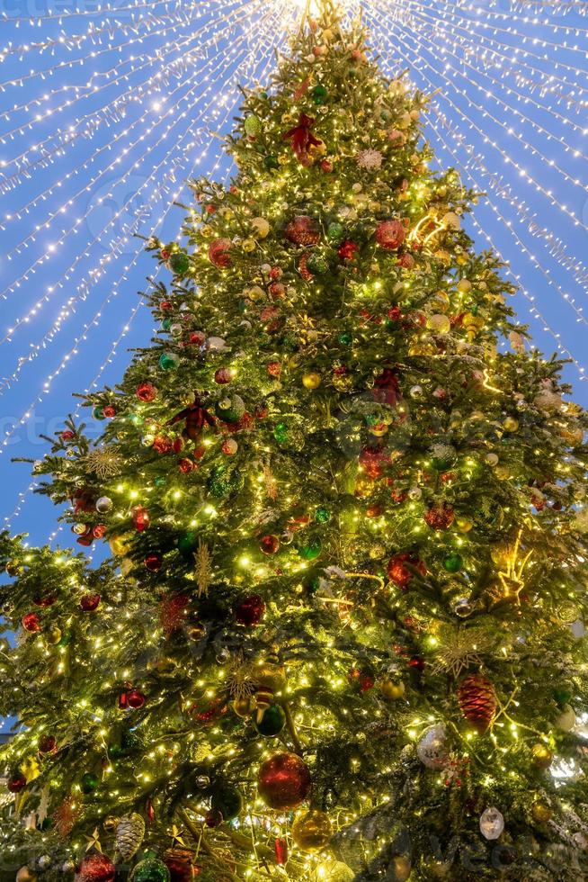 close up of christmas tree decoration with baubles and garland. Festive greeting card for winter holidays. photo