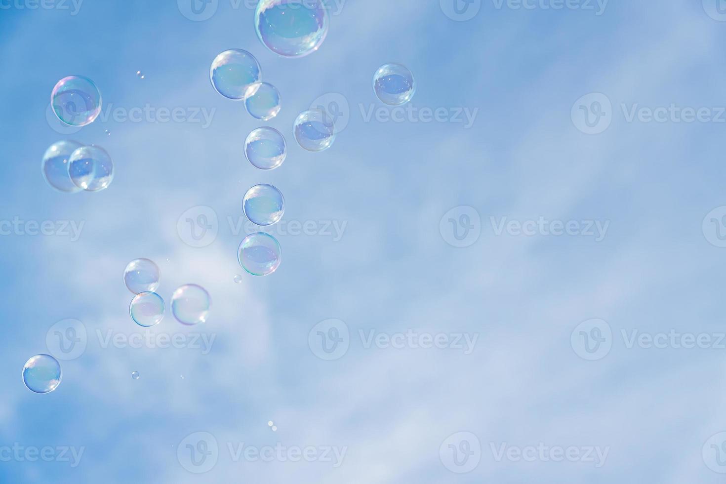 Abstract background, soap bubbles on blue sky background. Copy space for text. photo