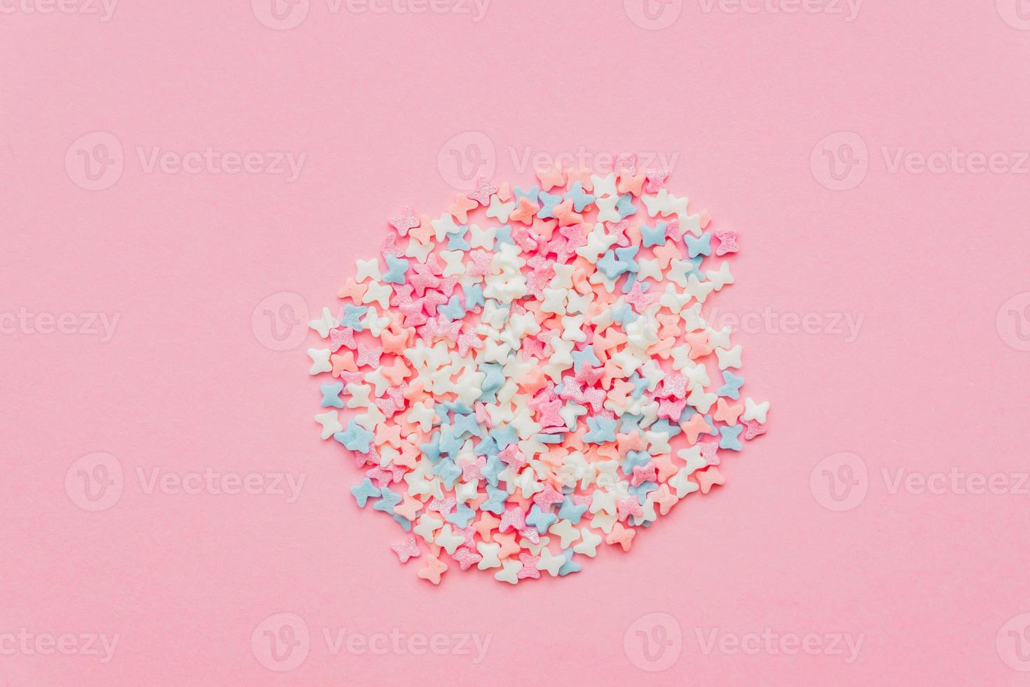 Sprinkle circle shape background. Sprinkle in the form of butterfly on pink background. copy space. top view photo