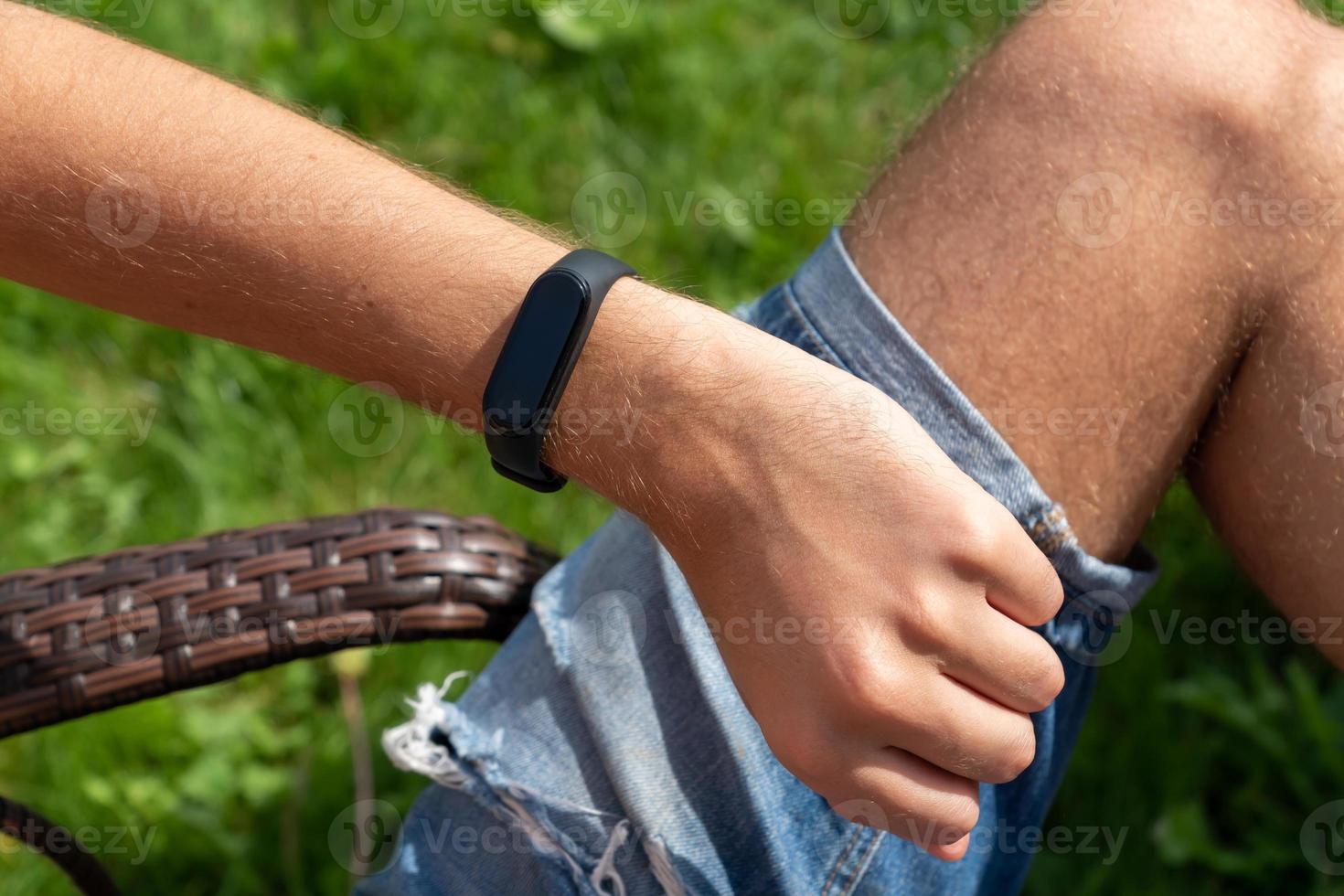 Close-up Of A Person Hand Wearing Smart Watch. fitness man using smart watch. photo