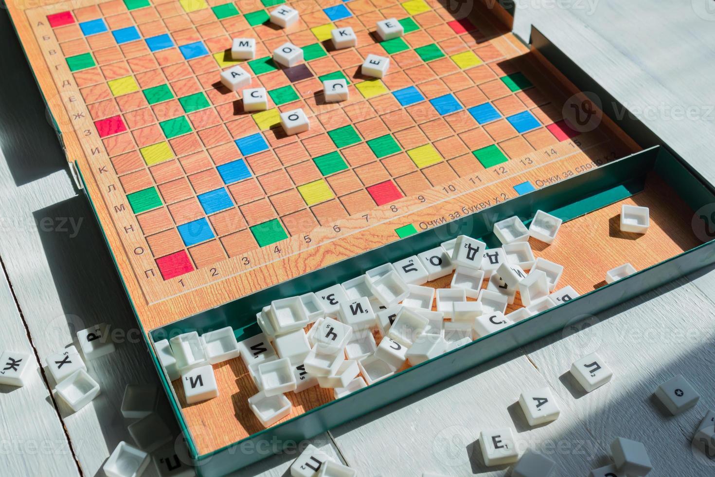 Scrabble game in Russian. Letters scattered on the game field photo