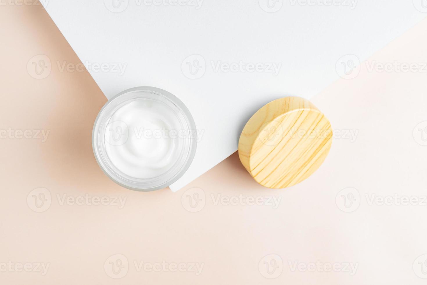 close up of collagen cream in glass jar and on white podium background. skin and body care beauty products. Mockup design photo