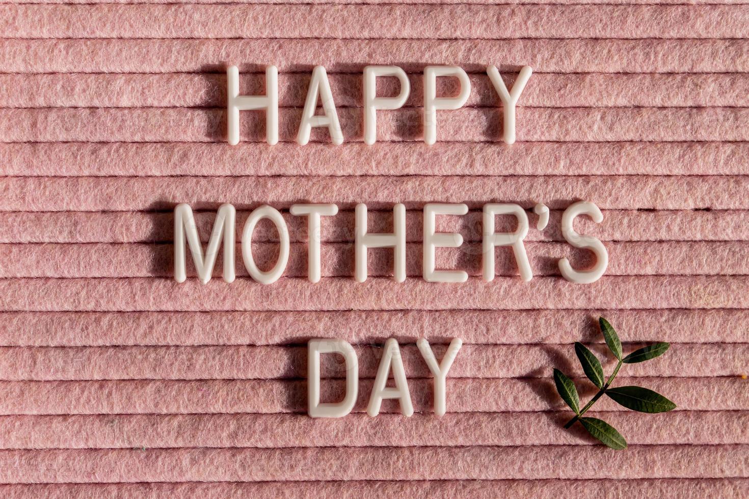 Happy Mother's Day letter board and green leaves.Mother's Day greting card. photo