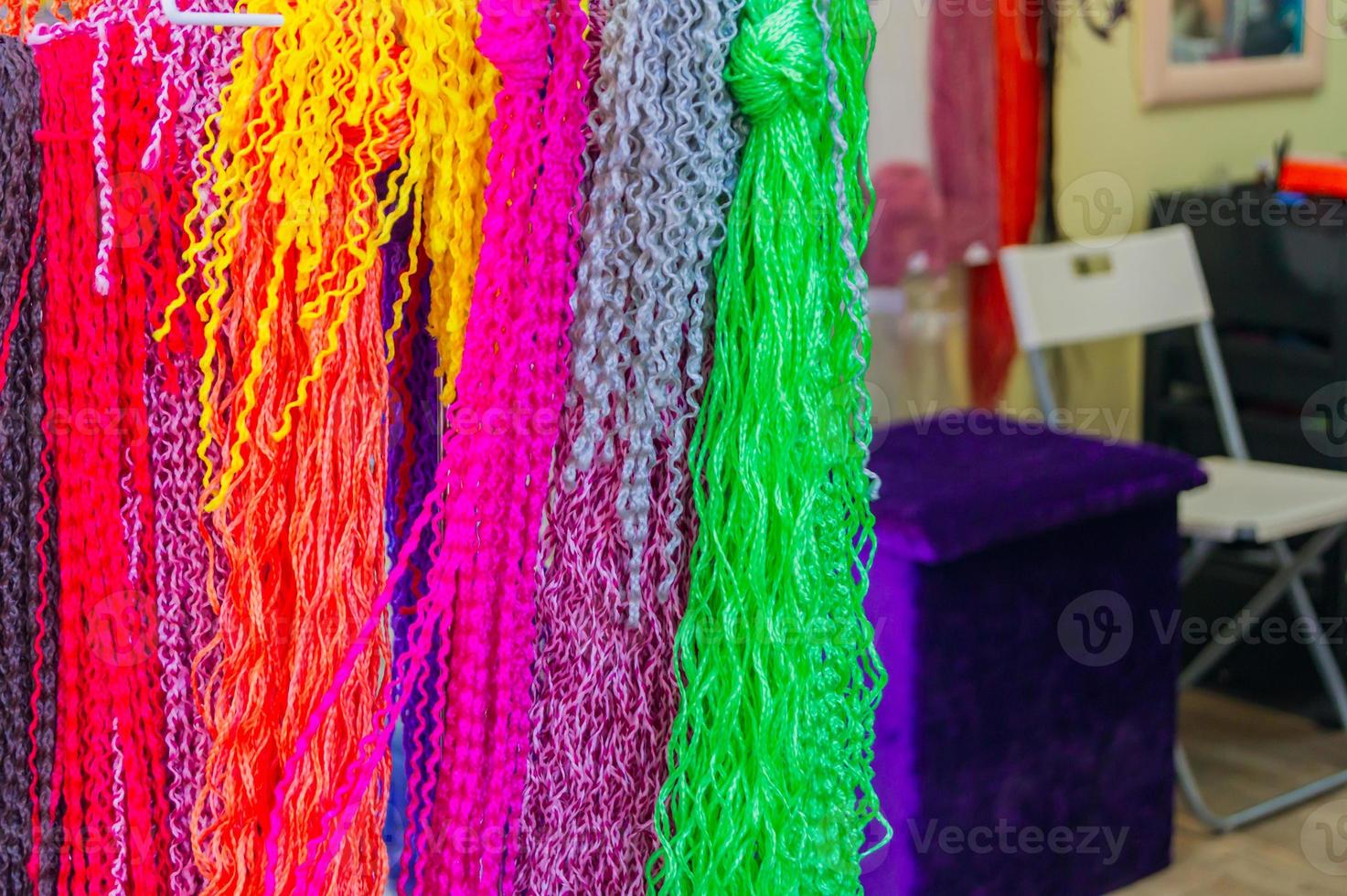 colorful strands of artificial hair for making African pigtails. photo