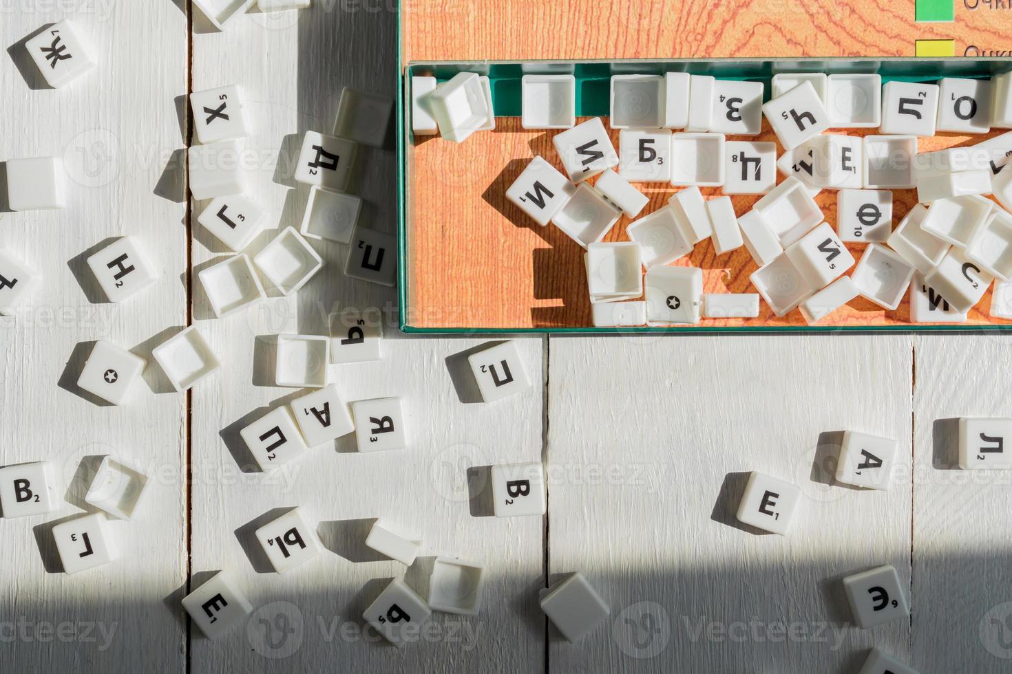 Scrabble game in Russian. Letters scattered on the game field photo