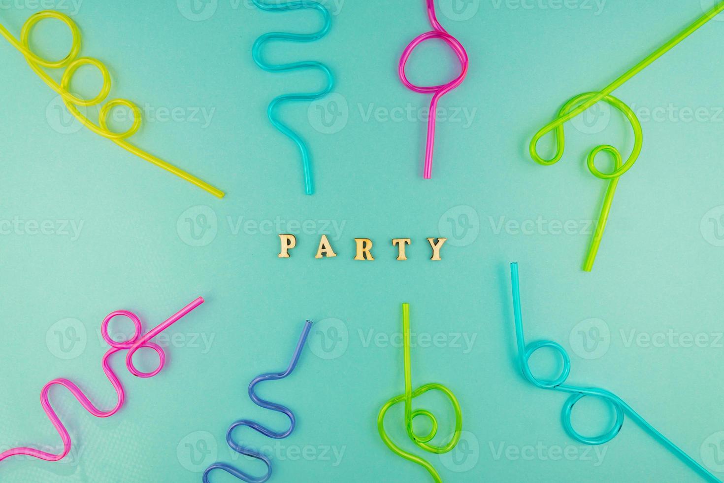 multicolored plastic cocktails straws on blue background photo
