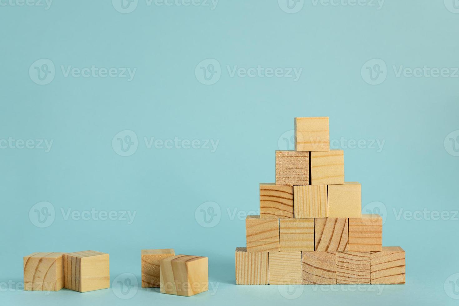 Construction of wooden cubes on blue background with copy space. Mockup composition for design photo
