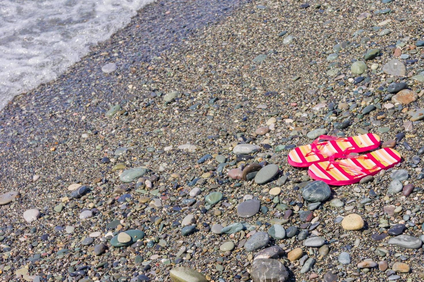 Woman's flip flops on the beach. Copy space. Tourism and vacation concept photo