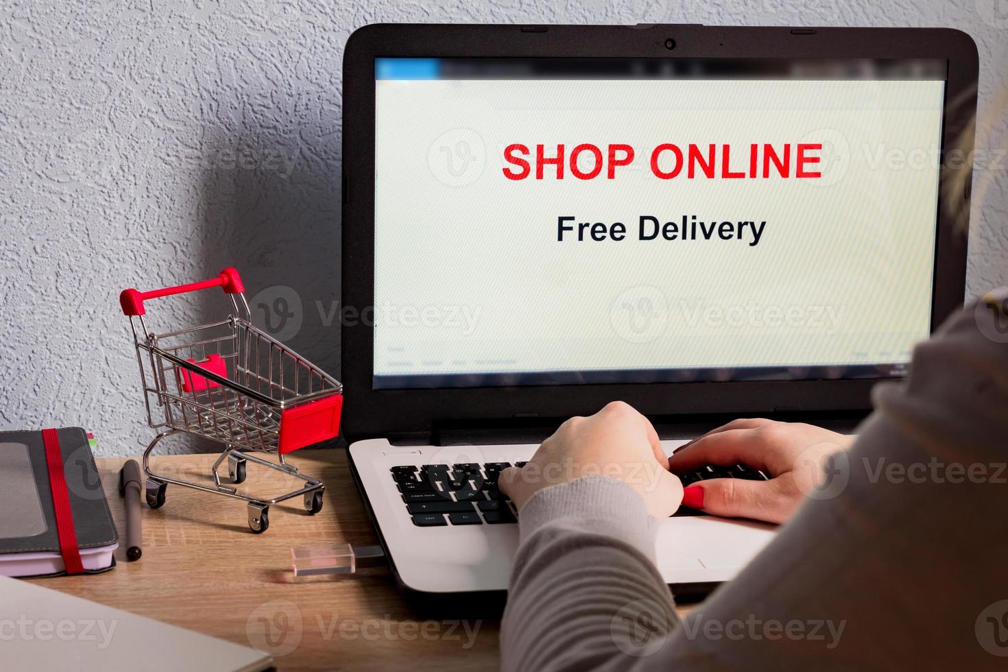 Shop online on Laptop Screen. Free delivery. E-commerce concept. Caucasian woman shop online from her home. photo