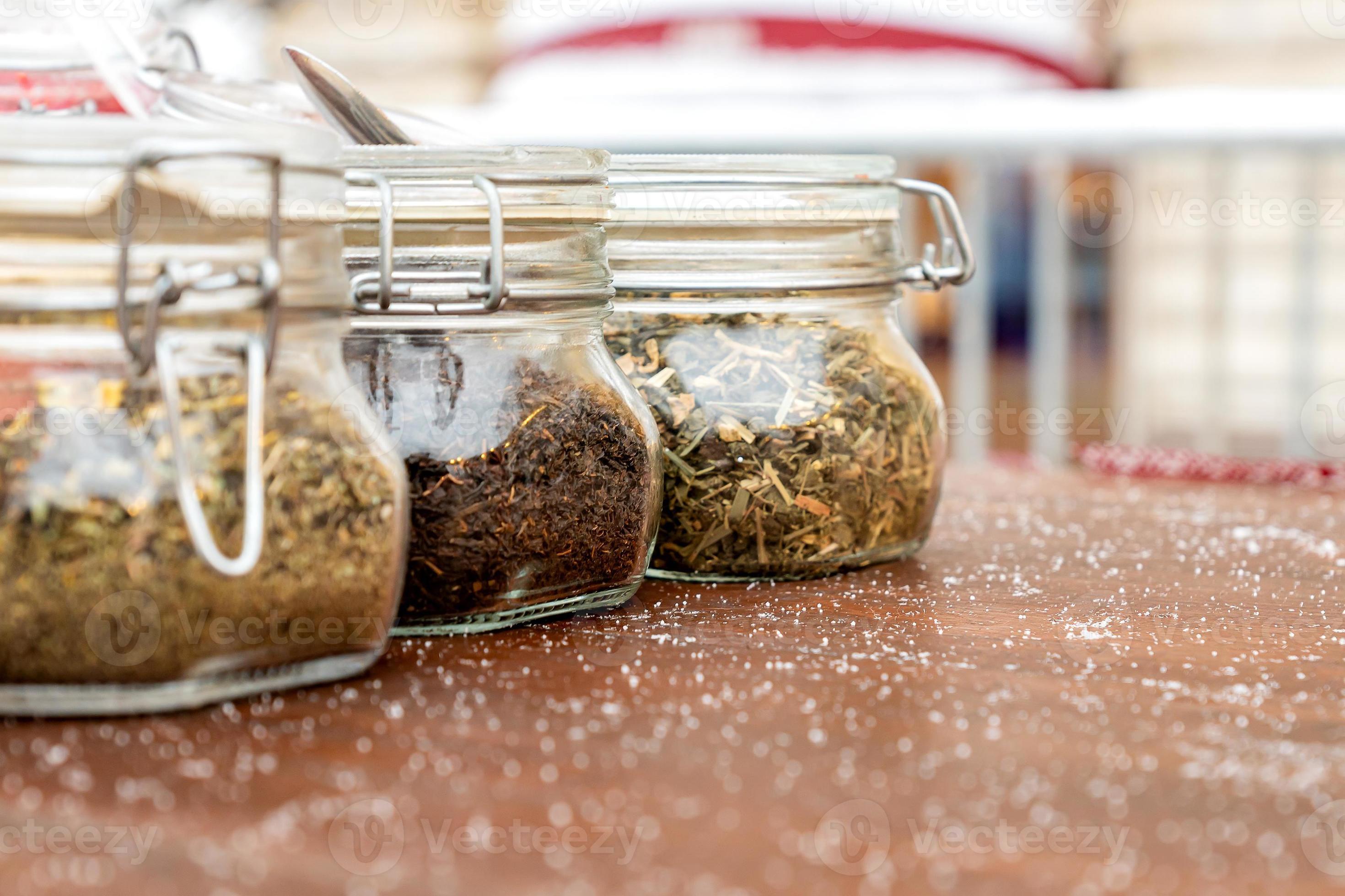 Jars with three different types of tea are on the table, alternative