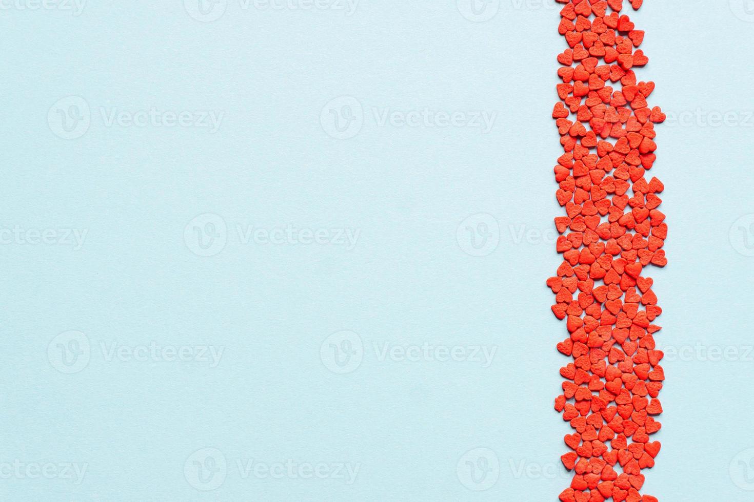 sprinkles background, sugar sprinkle red hearts, decoration for cake and bakery. Top view, flat lay. Valentines holiday photo