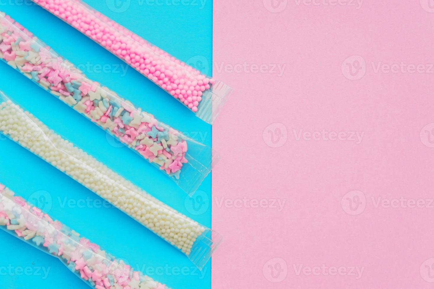 Set of sugar sprinkles of white, pink and blue colors in shape of stars, balls and butterflies. Decoration for cakes and bakery. photo