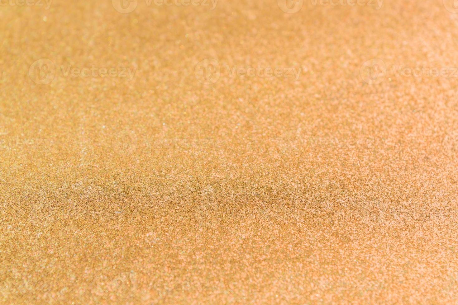 Abstract background texture with golden sparkling glitter. Festive backdrop for greeting cards and other design photo