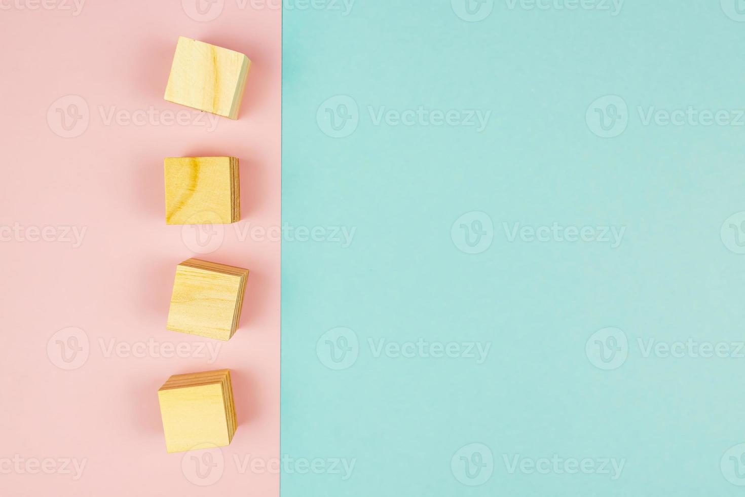 four wooden cubes on pink background. Creative flat lay with copy space. Mockup for design photo