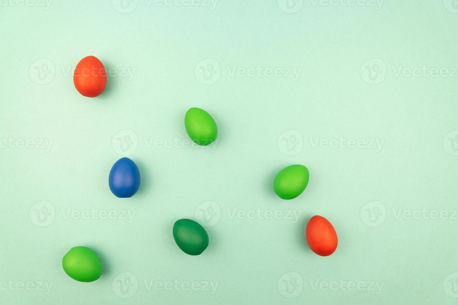 multicolored easter eggs on light blue background with copy space photo