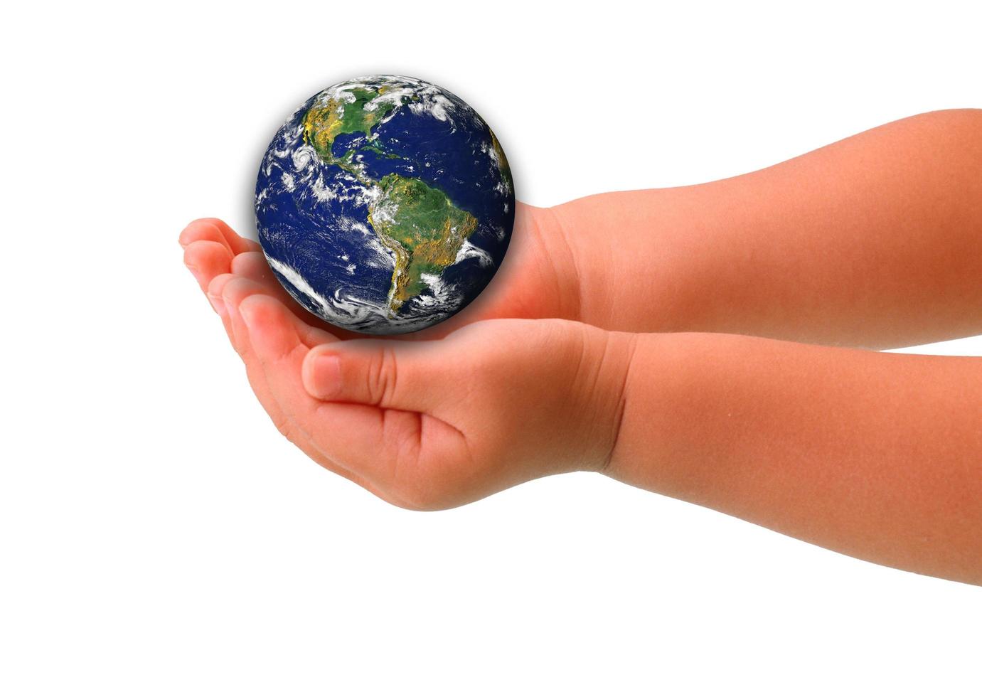 The globe in hands of the child,isolated on a white photo