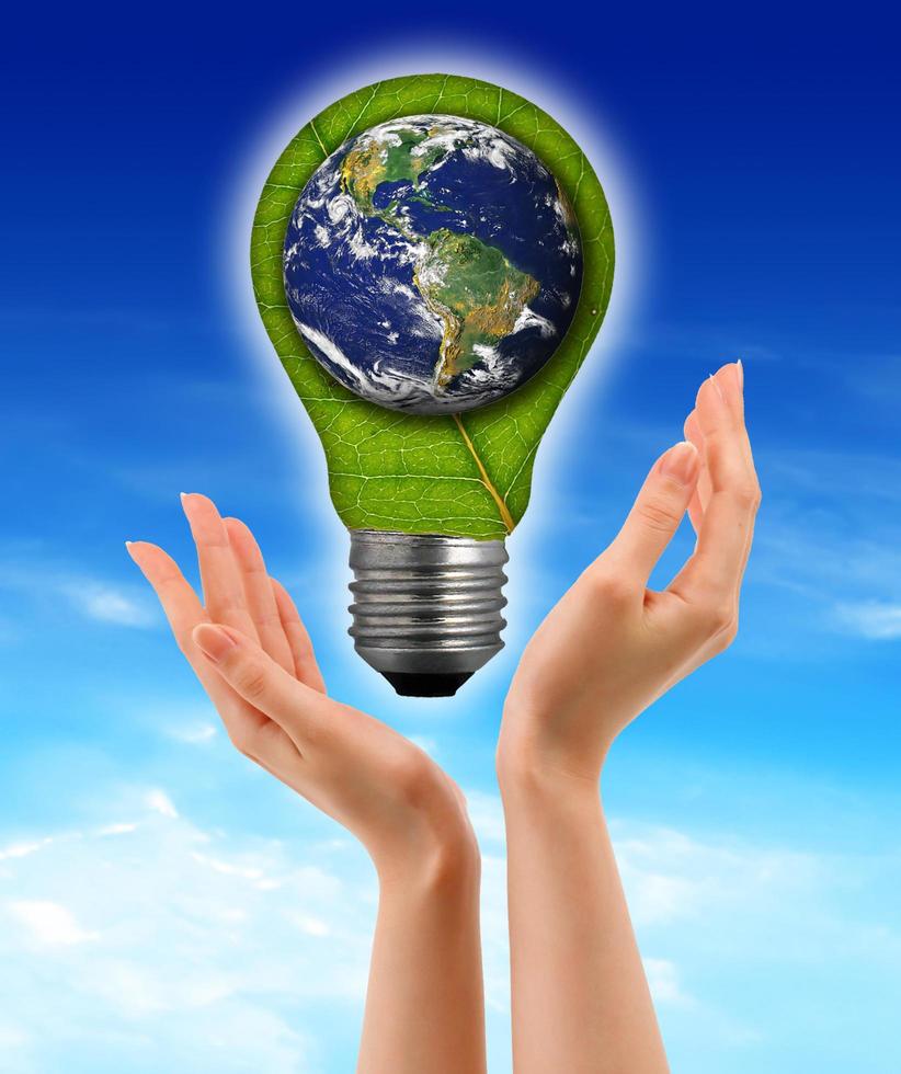 Ecological concept, leaf and lamp mixed together with hand photo