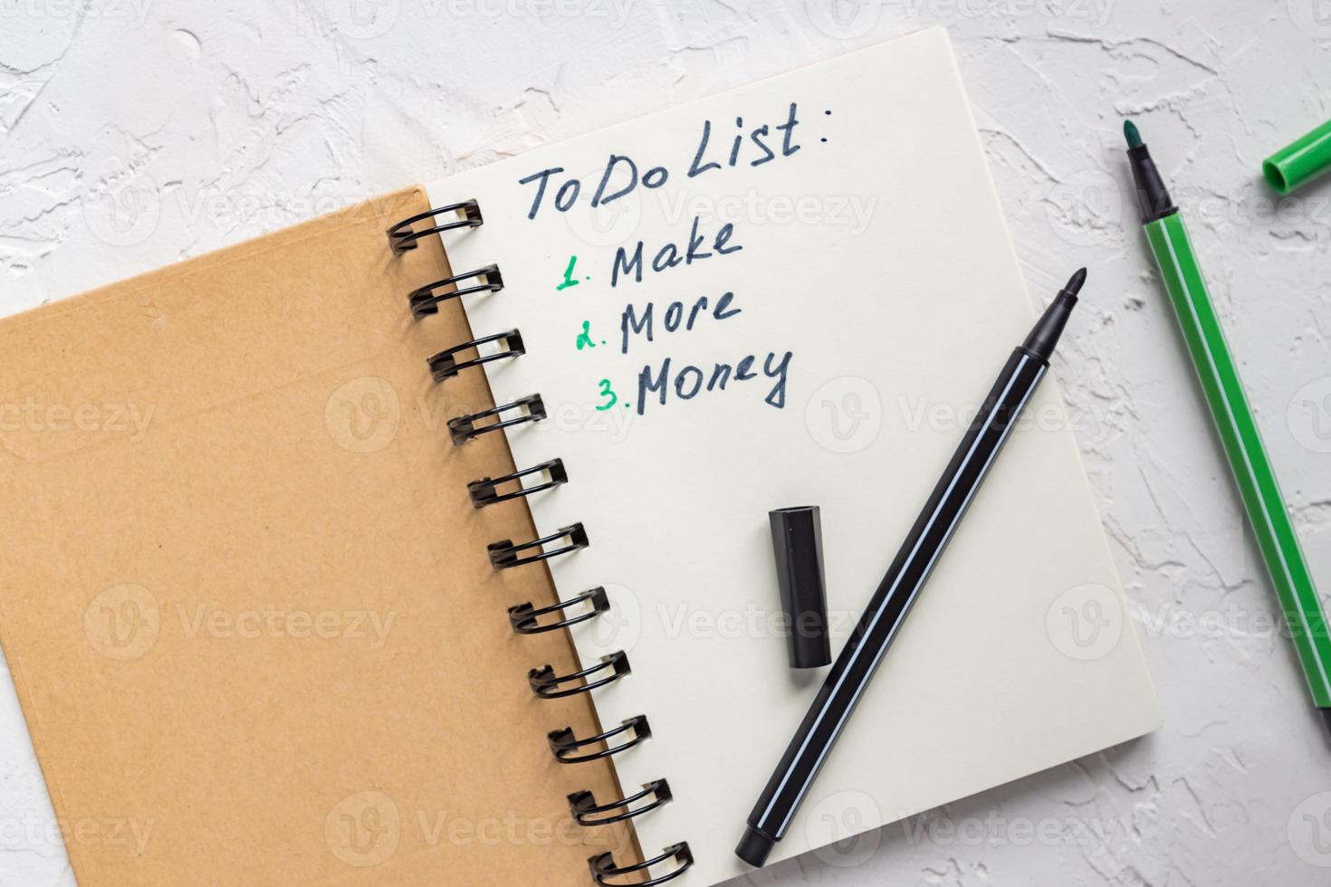 To do list - make more monTo do list - make more money written text on note pad. Close upe written text on note pad. photo