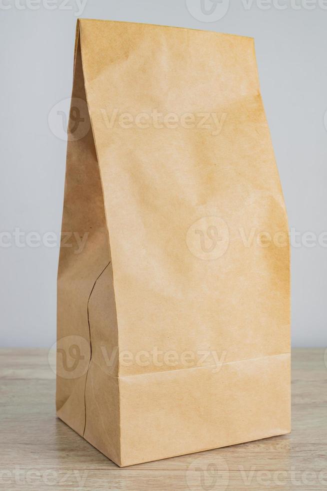 Close up of craft blanck paper bag for food delivery. Mock up for designers. Shopping and delivery concept photo