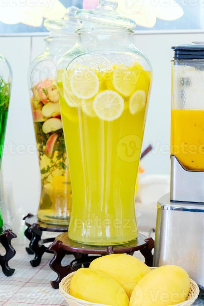 Jar of lemonade. fresh sliced lemons. Ice cold useful juicy beverage. Refreshing drink during Summer time photo