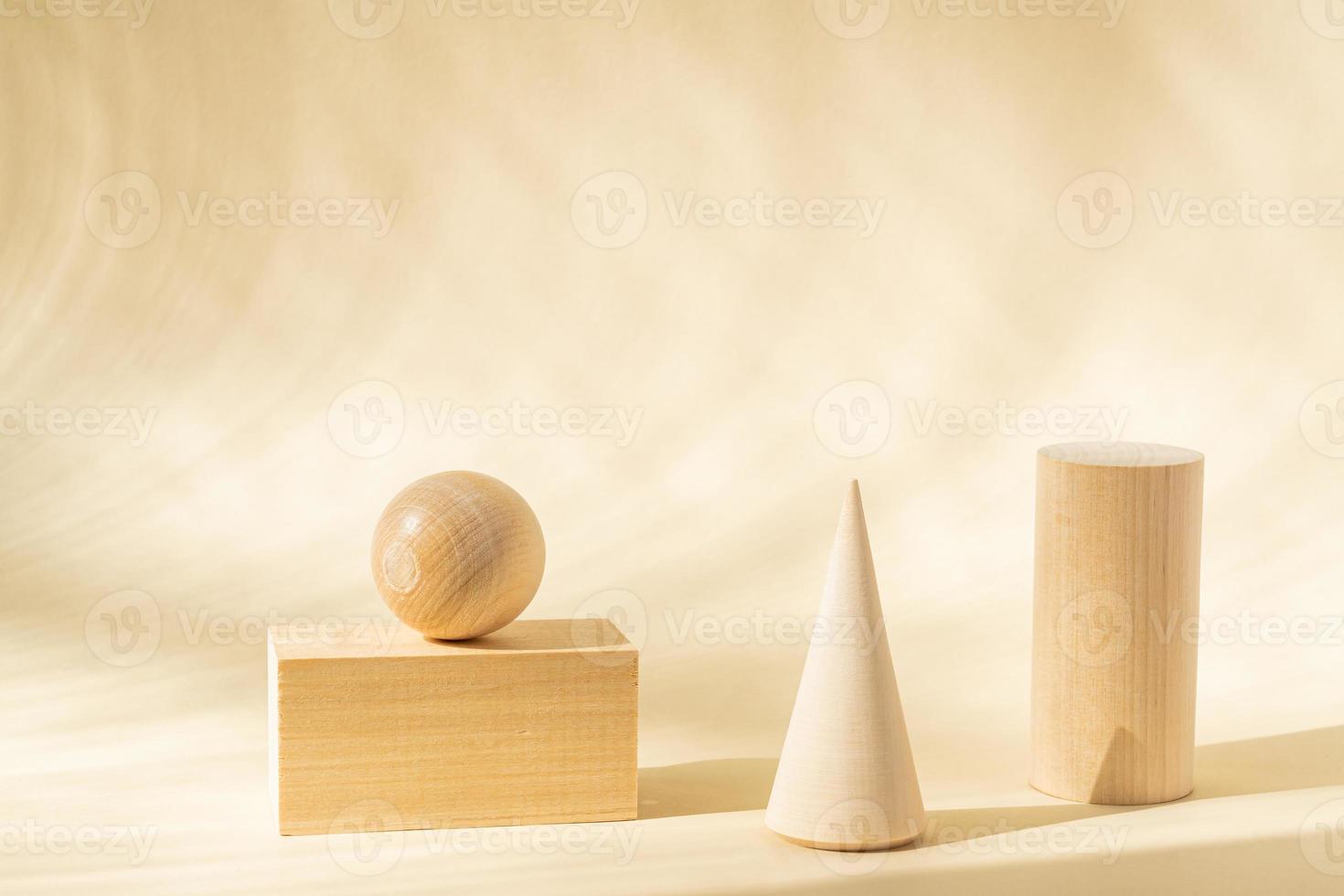 Stands for product of wooden natural shapes. Cube, ball and cone as podiums. Creative composition on beige background. photo