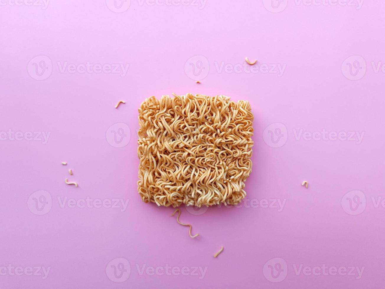 Top view instant noodle on pink background photo