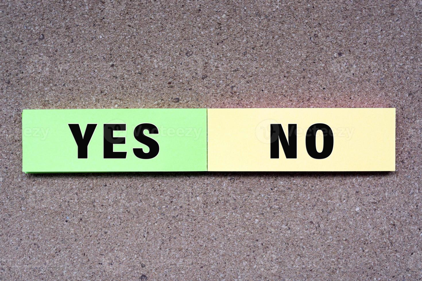 Yes No written on note with wooden background. Approved and Declined concept. photo