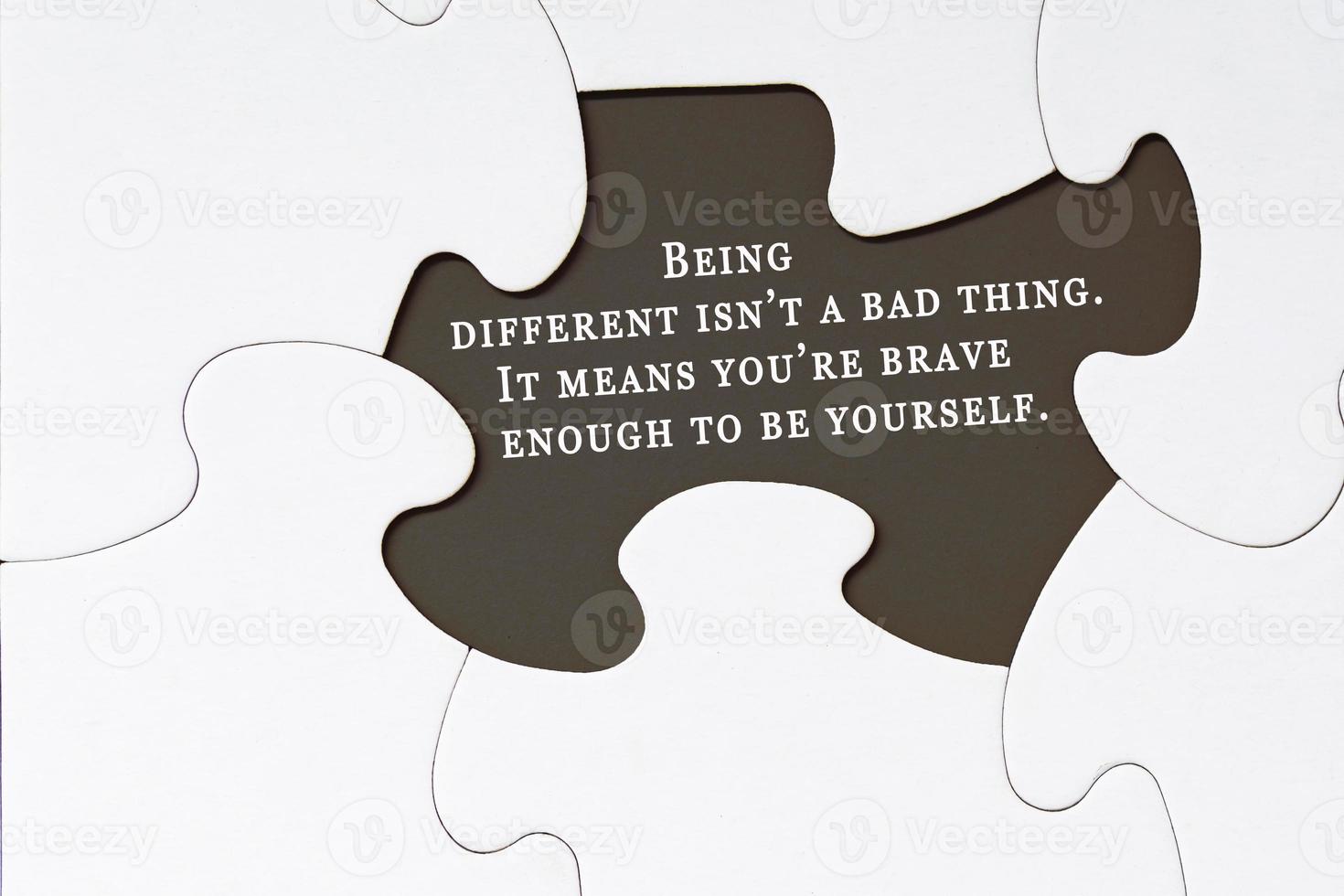 Motivational quote on white jigsaw puzzle with some missing pieces. photo